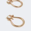 Boucles d’oreilles Monogram en métal doré Boucles d’oreilles Monogram en métal doré